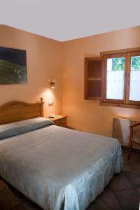 a bedroom with a large bed and a window at Apartamentos Cuevas del Mar in Nueva de Llanes