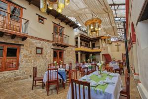 a restaurant with tables and chairs in a building at Hotel San Marcos in San Cristóbal de Las Casas