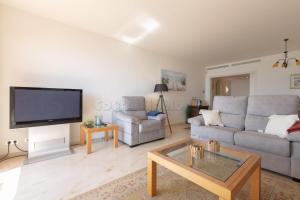 a living room with a couch and a tv at los granados 1221 in Manilva