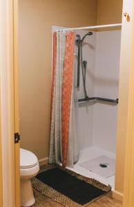 a bathroom with a shower curtain and a toilet at Old Brewery Hostel in Tonopah