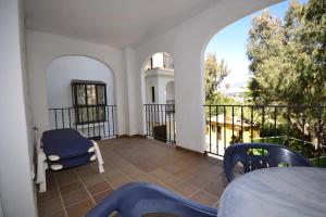 a room with a balcony with a table and chairs at marina duquesa 616 in Manilva