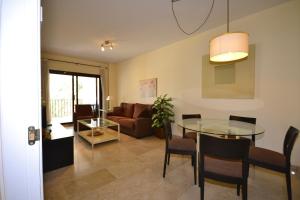 a living room with a glass table and a couch at marina duquesa 616 in Manilva