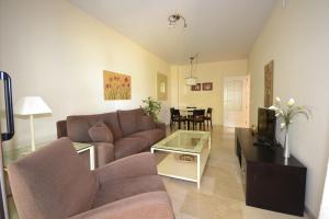 a living room with a couch and a table at marina duquesa 616 in Manilva