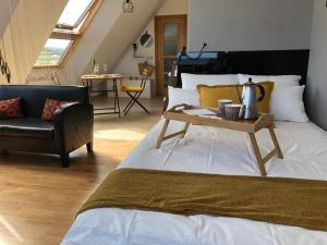 a bedroom with a bed with a table and a chair at El Rinconcito de Foz in Foz