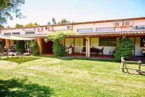 a house with a yard in front of it at Borgo S.Maria Di Vulci in Montalto di Castro