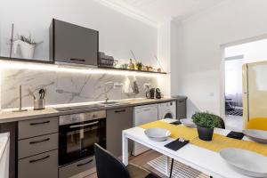 a kitchen with a table and a sink and a stove at Martin Boutique Hotel in Plauen