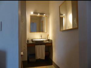 a bathroom with a sink and a mirror at Herdade da Carapuça in Portalegre