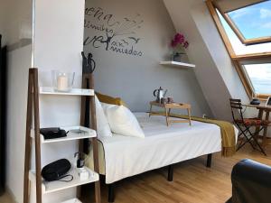 a bedroom with a bed with white shelves at El Rinconcito de Foz in Foz