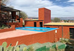 a swimming pool on the roof of a house at Alondra Boutique in Villa Cura Brochero