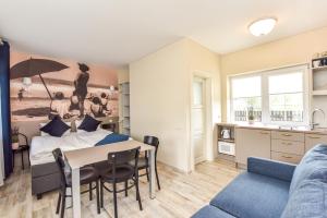 a bedroom with a bed and a table and chairs at Palanga INN in Palanga +47 photos