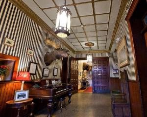 a hallway with a room with a piano and a room with at Amsterdam Castle NY in Amsterdam