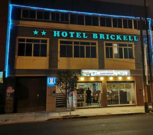 a hotel building with a sign on it at night at Hotel Brickell in Lima