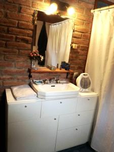 a bathroom with a white sink and a mirror at EL Arka in San Carlos de Bariloche