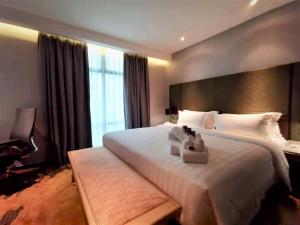 Postel nebo postele na pokoji v ubytování King Park Hotel Kota Kinabalu