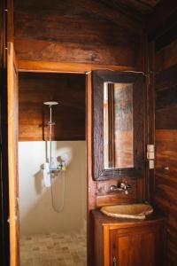 a bathroom with a sink and a mirror at Baligong Villa in Sukawati