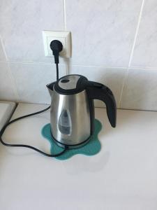 a tea kettle is plugged into a electrical outlet at Apartment Green in Sarajevo