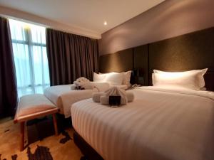 Postel nebo postele na pokoji v ubytování King Park Hotel Kota Kinabalu
