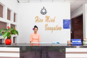 a woman standing behind a counter in a room at Resort Hien Minh Bungalow in Phú Quốc