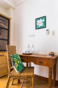 a wooden desk with a chair with a pillow on it at Talisay Boutique Hotel in El Nido