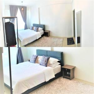 a hotel room with two beds and a mirror at Lvl 22 City Park View 3BR Full Aircond with Pool at Casa Kayangan Meru in Ipoh