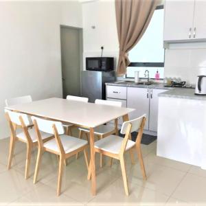 a kitchen with a table and chairs in a kitchen at Lvl 22 City Park View 3BR Full Aircond with Pool at Casa Kayangan Meru in Ipoh