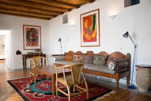 a living room with a couch and a table at Τhe White Houses in Makry Gialos