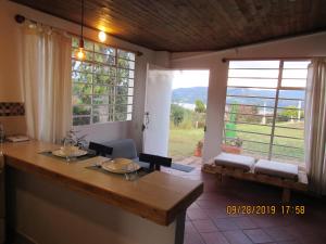 uma cozinha com uma mesa e uma grande janela em Casa rural tipo loft em Guatavita