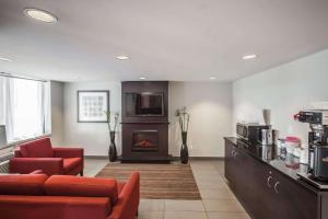 a living room with a couch and a fireplace at Comfort Inn West in Edmonton