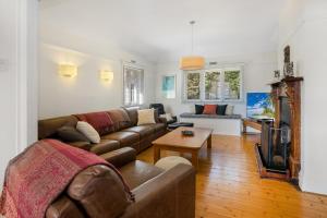 a living room with a couch and a table at Ellis Cottage Sorrento plus Guest House in Sorrento