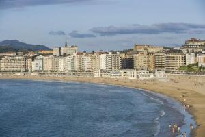 a view of a beach with hotels and buildings at Hotel Niza in Donostia-San Sebastián