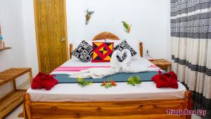 a bedroom with a bed with red flowers on it at Triangle Home Stay in Dambulla