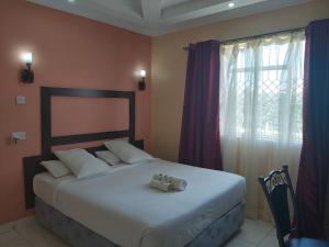 Ένα ή περισσότερα κρεβάτια σε δωμάτιο στο Sahara Gardens Bomet +50 φωτογραφίες