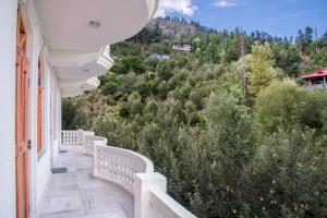 a balcony with a view of a mountain at The Wild Trails by Livingstone in Kalpa