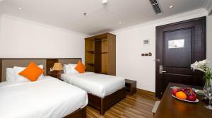 Postel nebo postele na pokoji v ubytování Roliva Hotel & Apartment Danang