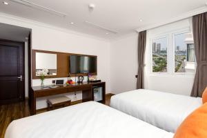 Postel nebo postele na pokoji v ubytování Roliva Hotel & Apartment Danang