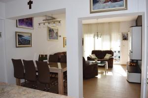 a kitchen and living room with a table and chairs at Rosemary Apartments in Duće