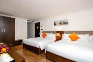 Postel nebo postele na pokoji v ubytování Roliva Hotel & Apartment Danang