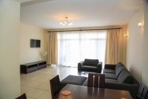 a living room with a couch and a table at Executive Suites in Kigali