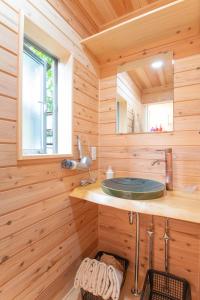 a wooden bathroom with a sink and a mirror at The EXP Yachiyo - Self Check-In Only in Uda