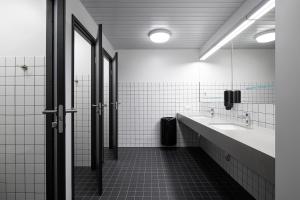 a bathroom with two sinks and a mirror at Neotel in Tallinn