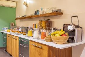 a kitchen with a counter top with fruit in at Le 20 Prieuré Hôtel in Paris