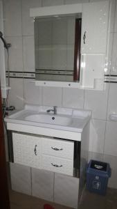 a bathroom with a sink and a mirror at The Pearl Inn in Koboko