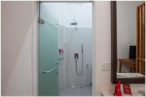 a shower in a bathroom with a glass door at Koolkost near Padang Galak Beach in Denpasar