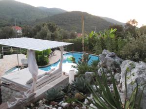 a villa with a swimming pool and mountains in the background at Relax tiny villas 40 meters of the beach in Korčula