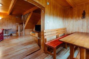 Cette chambre en bois comprend un banc et une table. dans l'établissement Chata Alpina, à Kľačno