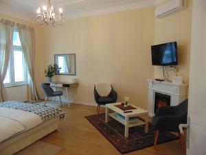 a bedroom with a bed and a fireplace and a tv at Apartments Radićeva in Zagreb