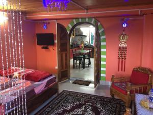 a bedroom with a bed and a dining room at Hidden Woods Homestay in Darjeeling