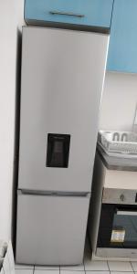 a white refrigerator with a microwave on top of it at Modern 1 bedroom apartment near the metro. in Ivry-sur-Seine +6 photos