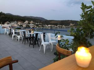 a patio with tables and chairs and a view of the water at Mistral-Καπος in Erateini +35 photos