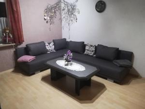 a living room with a couch and a coffee table at Ferienwohnung Preuß in Martinlamitz